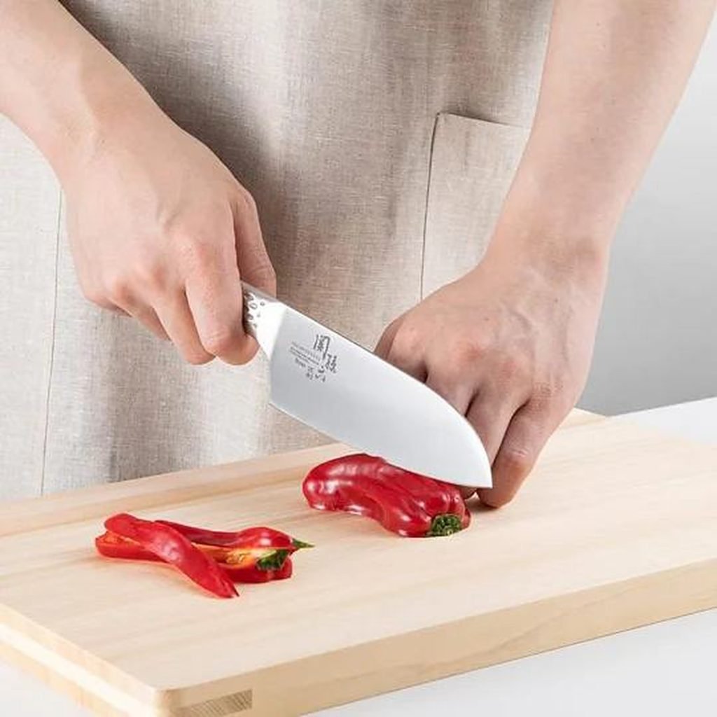 Santoku knife slicing red pepper